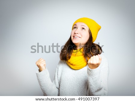 beautiful winter young woman celebrating success, isolated close-up