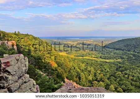 Beautiful Wisconsin summer nature background. Areal view from rocky ice age hiking trail during sunset hours. Devil's Lake State Park, Baraboo area, Wisconsin, Midwest USA.