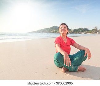 Beautiful Woman 50 Years Sitting On The Beach After Yoga