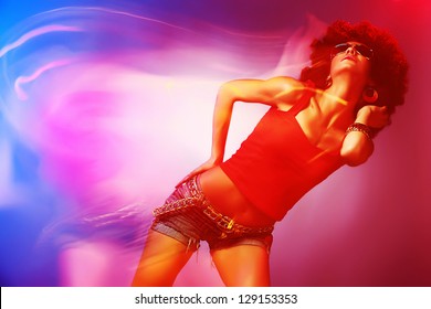Beautiful woman with afro haircut is dancing disco. Photo with blurred effects.