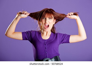 Beautiful woman with a angry expression pulling her hair