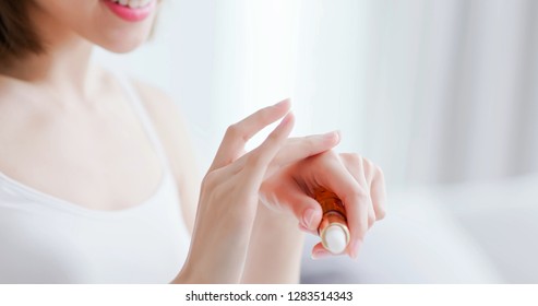 Beautiful Woman Apply Moisturizer Into Her Hand At Home