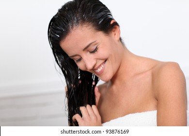 Beautiful Woman Applying Hair Conditioner