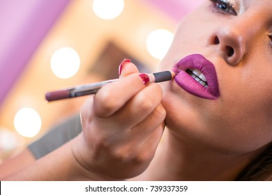 Beautiful Woman Applying Lip Liner To Lips. Close Up.