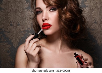 Beautiful Woman Applying Red Lipstick