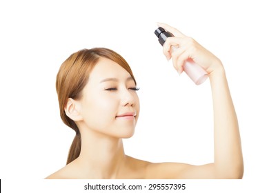 Beautiful Woman Applying Spray Water Treatment On Face