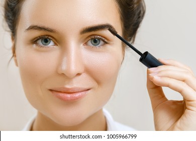 Beautiful Woman Is Applying Tinted Eyebrow Gel