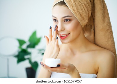 A Beautiful Woman Asia Using A Skin Care Product, Moisturizer Or Lotion And Skincare Taking Care Of Her Dry Complexion. Moisturizing Cream In Female Hands