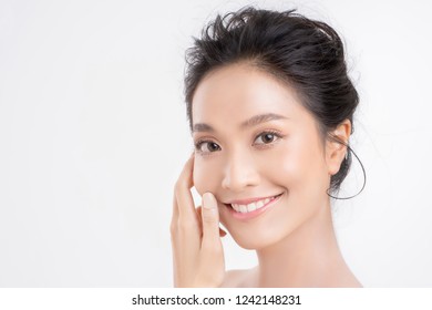 Beautiful Woman Asian Face Close Up Studio .She Is Holding Her Cheeks.