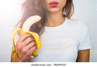 Beautiful Woman With Big Lips Holds A Fresh Food Fruit Banana