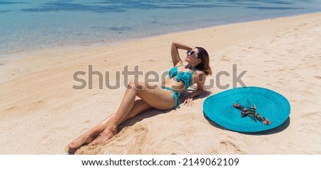 beautiful woman in bikini by the sea.