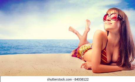 Beautiful woman in bikini sunbathing at the seaside - Powered by Shutterstock