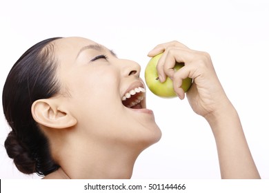 Beautiful woman biting apple