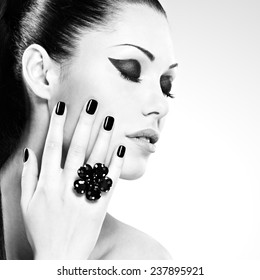 Beautiful  woman with black nails posing at studio