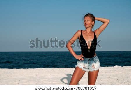 Similar – Young, long-legged woman sitting on the Baltic Sea beach