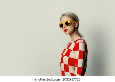 Beautiful Woman With Blond Hair In In A 70s Red Square Dress With Sunglasses