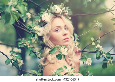 Beautiful Woman With Blonde Hair On Spring Blossom Background