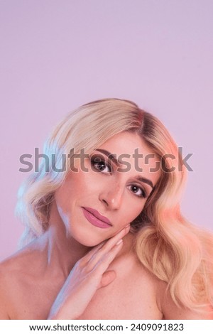 Beautiful Woman Blonde Rose Lips Healthy Beauty Skin Smile. Spa Beautiful Model Girl Cute Face over black background. Studio shot. High quality photo