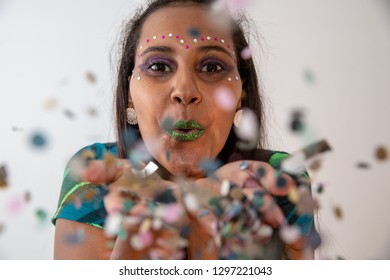 Beautiful Woman Blow Confetti From Hands. Celebration, Event Or Carnival Concept. Movement And Happiness Having Fun. Brazilian Carnaval.