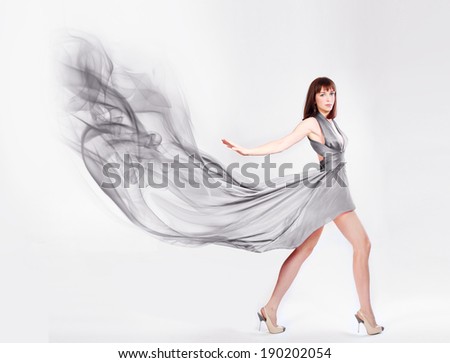 Beautiful woman in blowing Dress