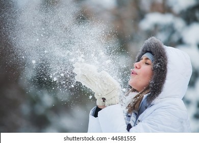 Beautiful Woman Blowing In The Snow