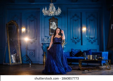 Beautiful Woman In A Blue Ball Gown And Blue Room