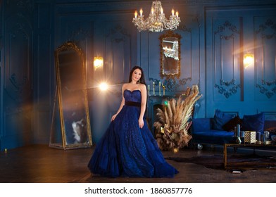 Beautiful Woman In A Blue Ball Gown And Blue Room