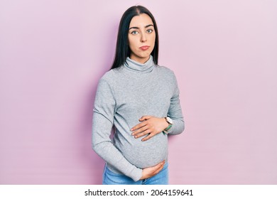 Beautiful Woman With Blue Eyes Expecting A Baby, Touching Pregnant Belly Depressed And Worry For Distress, Crying Angry And Afraid. Sad Expression. 