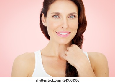 Beautiful woman with blue eyes on pink background.