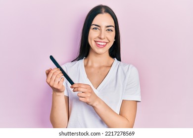 Beautiful Woman With Blue Eyes Using File Nail Smiling With A Happy And Cool Smile On Face. Showing Teeth. 