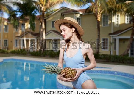 Beautiful woman blue swimsuit hotel vacation tropics lifestyle pool