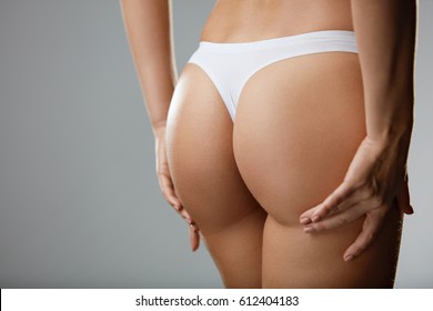 Beautiful Woman Body In Shape. Ð¡loseup Healthy Girl With Fit Slim Body, Soft Skin And Firm Buttocks, Hips In White Bikini Panties. Female With Sexy Back, Tight Big Butt In Underwear. High Resolution 