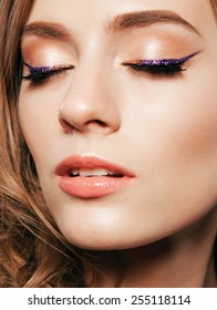 Beautiful Woman With Bright Make Up Eye With Sexy Violet Liner Makeup. Fashion Glitter Arrow Shape On Woman's Eyelid. Chic Evening Make-up