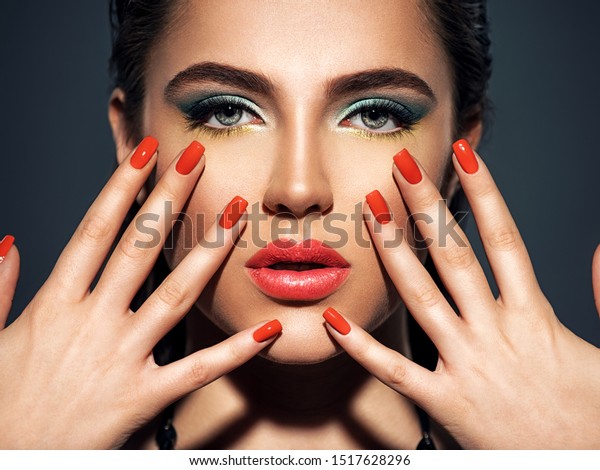 red lipstick and red nail polish