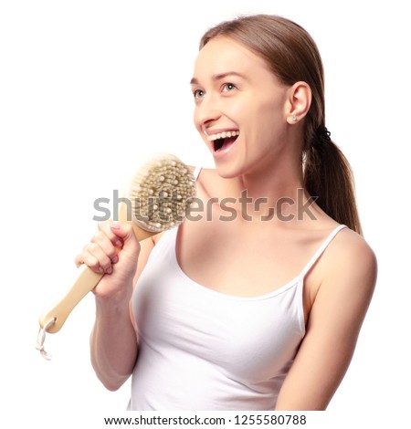 Beautiful woman brush from cellulite in hands on a white background. Isolation