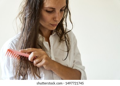 Beautiful Woman Brushing Her Wet Messy Hair After Bath With Comb. Thin Hair Porblem