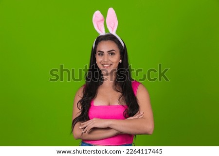 Beautiful woman with bunny ears happy with cross arms. Happy easter! 