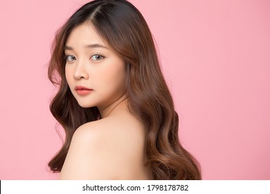 Beautiful woman bust up image isolated on pink studio background