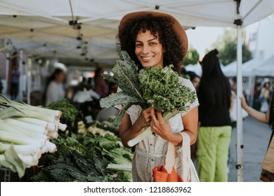 Beautiful Woman Buying Kale At A Farmers Market