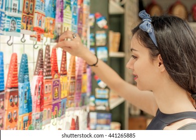 Beautiful Woman Buying Souvenirs In Gift Shop