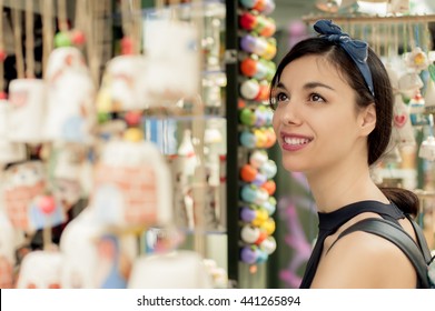 Beautiful Woman Buying Souvenirs In Gift Shop