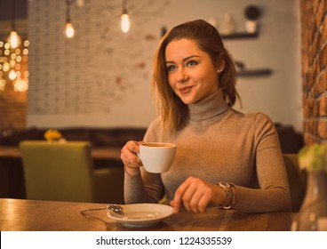 Beautiful woman in a cafe drinking coffee