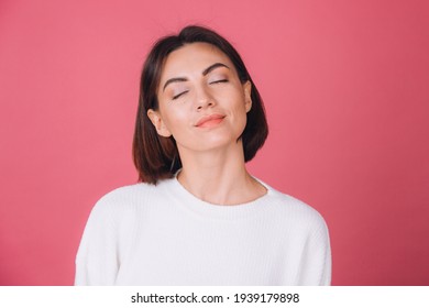 Beautiful Woman In Casual White Sweater On Pink Red Background Isolated Standing Calm Face Closed Eyes Cute Smile Copy Space