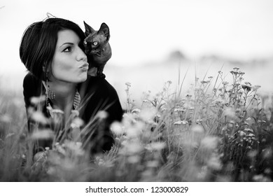 Beautiful Woman With Cat Lying In A Grass