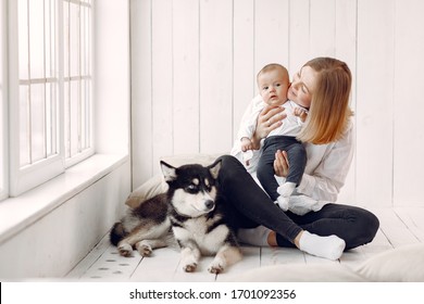 Beautiful woman with child. Woman in a white shirt. Family playing with big dog. - Powered by Shutterstock