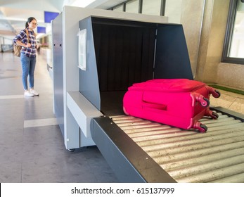 Beautiful Woman Chinese Waiting Luggage Through Point Of Checking The Scanner. Baggage X-ray Machine Band On The Conveyor Belt At The Airport.