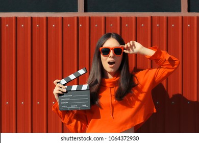 Beautiful Woman With Cinema Clapper On Red Background. Cool Model Girl With Film Slate At Casting Audition
