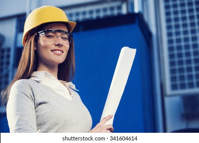 Beautiful Woman Civil Engineer Is Posing For Success In Front Of A Building