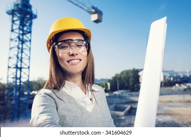 Beautiful Woman Civil Engineer Is Taking A Self Portrait In Her Work In Front Of A Crane