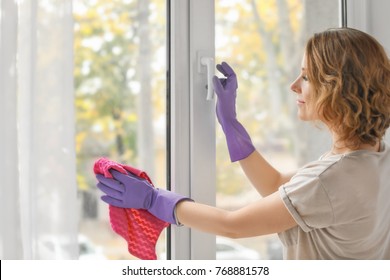 Beautiful Woman Cleaning Window At Home